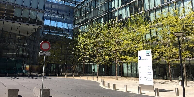 Swiss Innovation Hub - Geneva. Outside of the building on a sunny day with trees in the foreground.