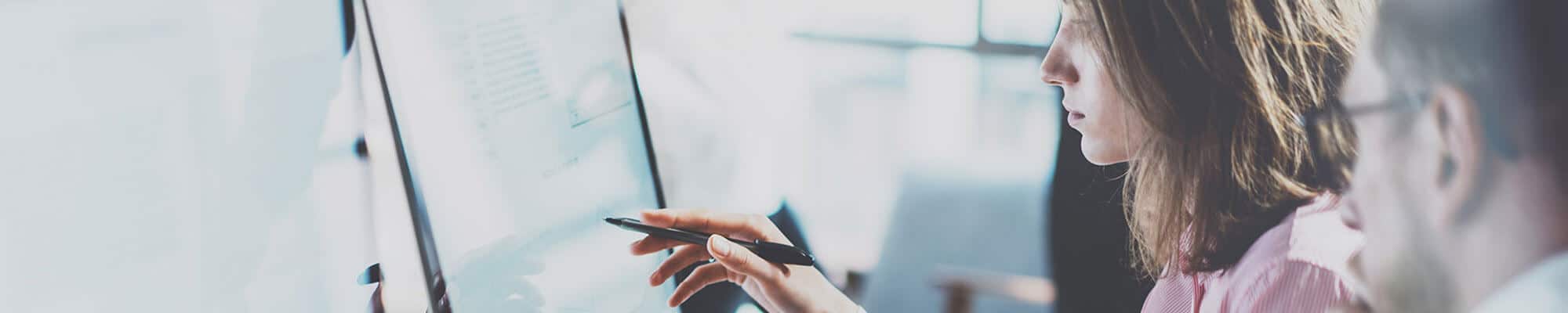 Woman pointing at something on a computer screen